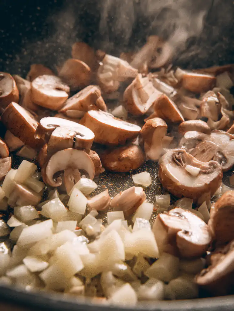 Clean Chicken Mushroom Soup The Ultimate Healthy & Comforting Bowl 4 brahim a Sliced mushrooms sauting in olive oil inside a large 06aecb77 2565 4b79 b090 e7eb5252ccaa 3